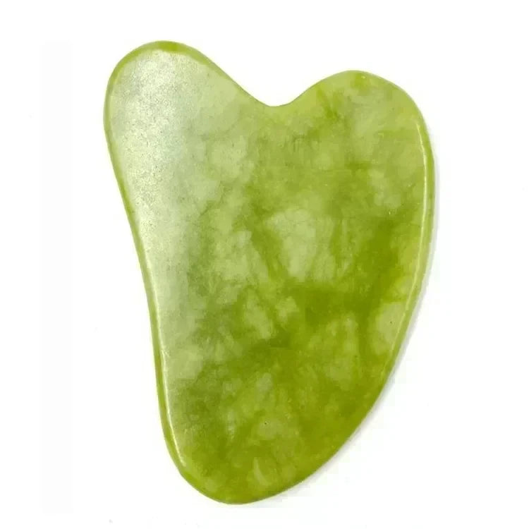 Green heart-shaped natural-stone gua sha tool on a white background