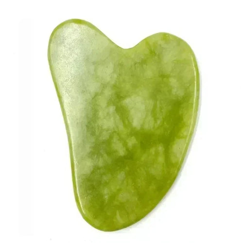 Green heart-shaped natural-stone gua sha tool on a white background